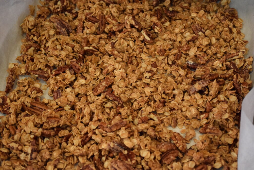Crunchy & Sweet Pieces of Oats & Pecans on a Baking Pan