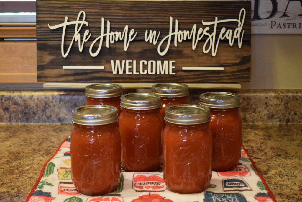Homemade Tomato Sauce in front of a The Home in Homestead Sign